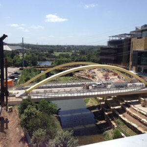 Construction site featuring a modern bridge under construction, surrounded by greenery and infrastructure, illustrating advancements in construction projects relevant to marketing strategies for the construction industry.
