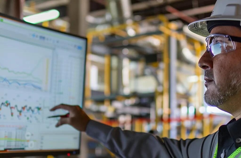 a construction company reviewing seo audit results on a computer screen, surrounded by charts and graphs representing ongoing optimization strategies.