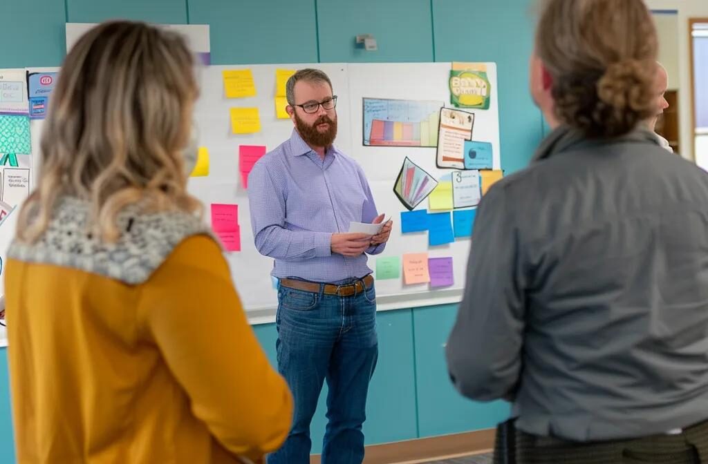 a group of business professionals gathered around a whiteboard, brainstorming and setting clear objectives for a referral program while holding colorful reward coupons.