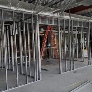 Construction site with metal framing for walls and a ladder, illustrating the building process relevant to construction SEO strategies.
