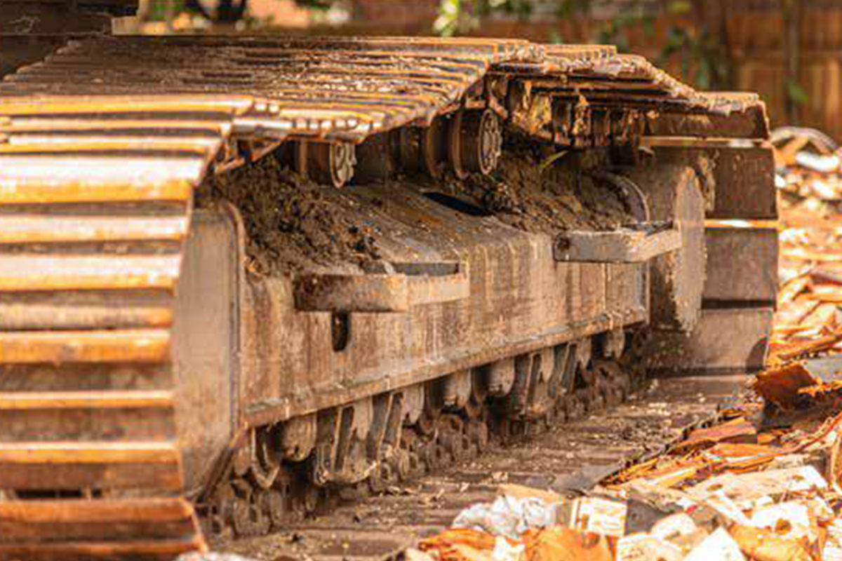 Construction machinery track with dirt and debris, illustrating construction site activity related to SEO benchmark report for contractors.