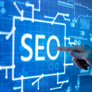 Hand pointing at "SEO" on a digital screen with circuit-like patterns, representing the intersection of traditional SEO and AI search strategies in construction marketing.