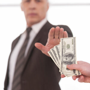Business professional rejecting cash offer, symbolizing wasteful spending on ineffective marketing strategies.
