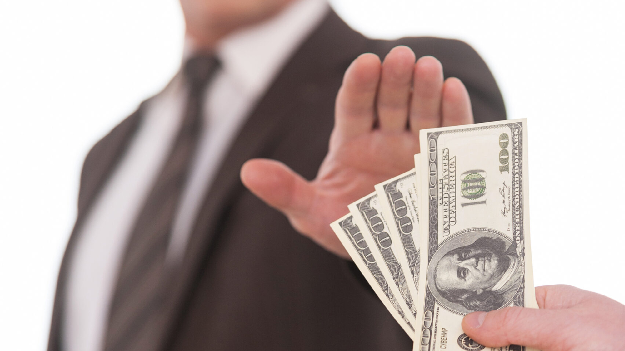 Businessman rejecting cash offer, emphasizing cost-saving strategies in construction bidding.